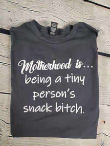 Motherhood is being a tiny persons snack b*tch t-shirt